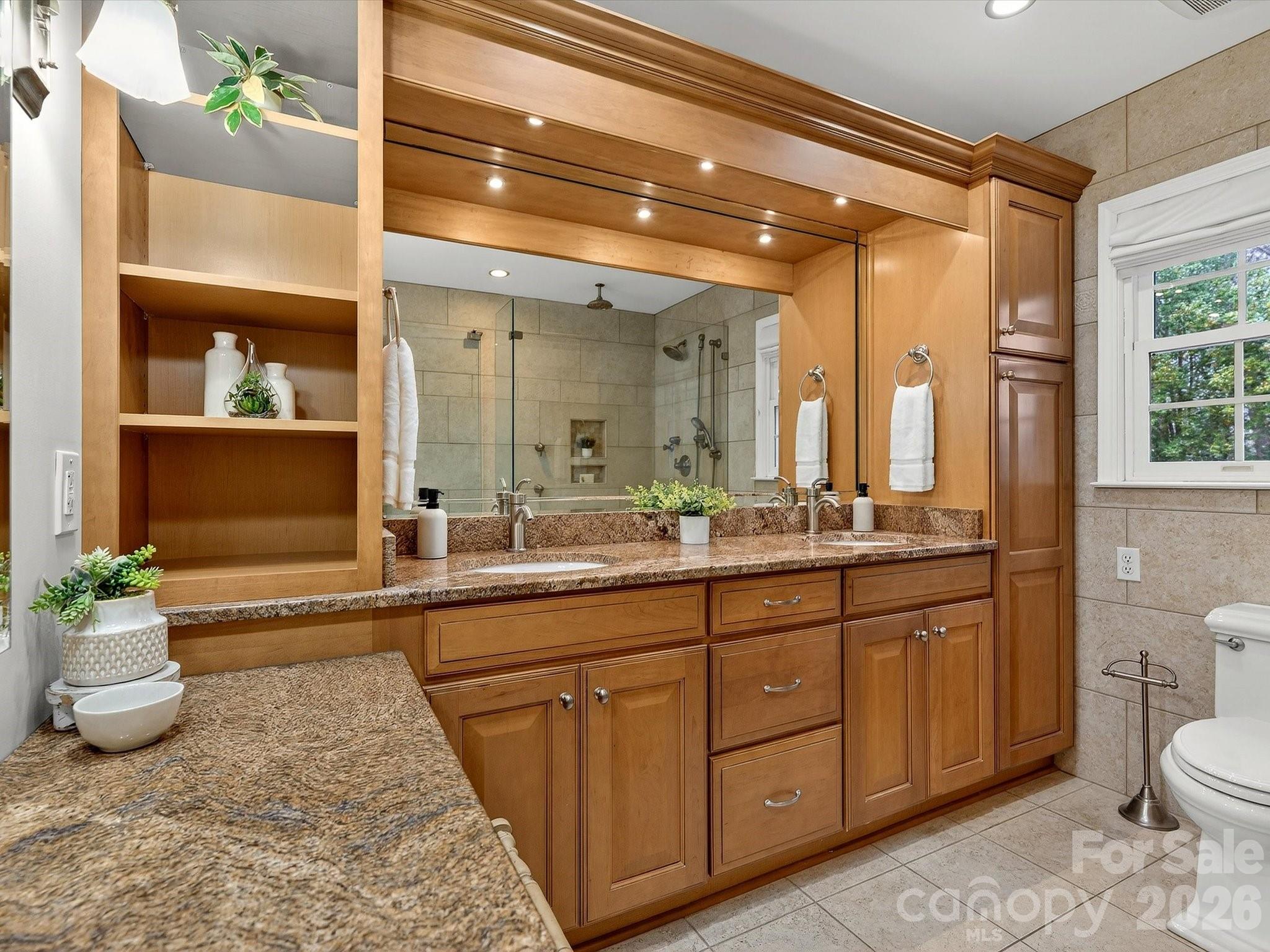 6344 Dovefield Road Charlotte, NC 28277 - Photo 27 of 46 a spacious bathroom with a granite countertop sink and a mirror