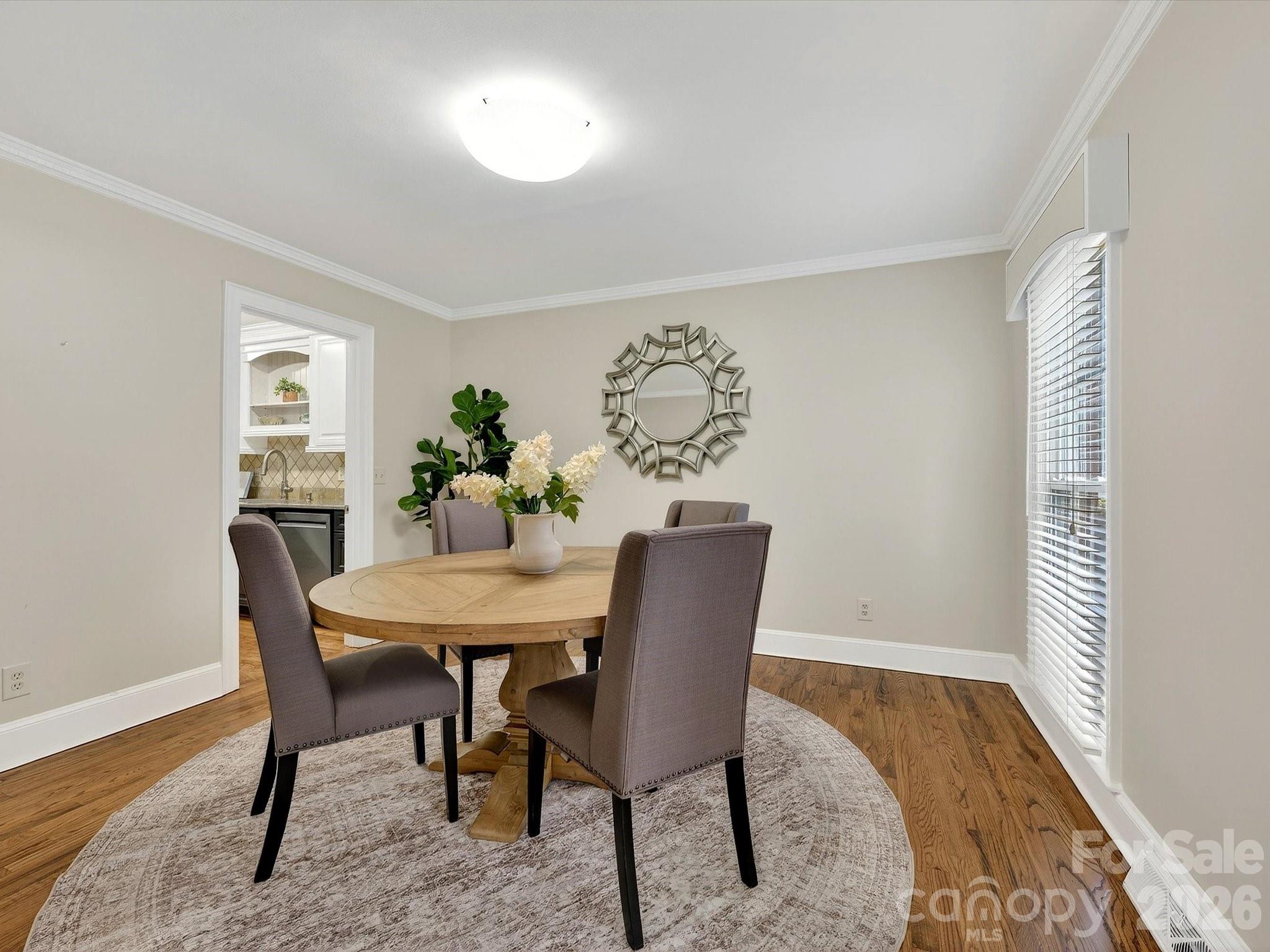 6344 Dovefield Road Charlotte, NC 28277 - Photo 8 of 46 a view of a dining room with furniture and wooden floor