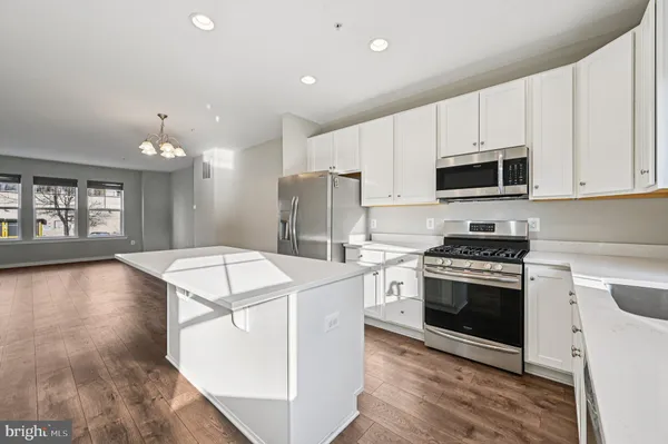 a kitchen with a stove a sink and a refrigerator