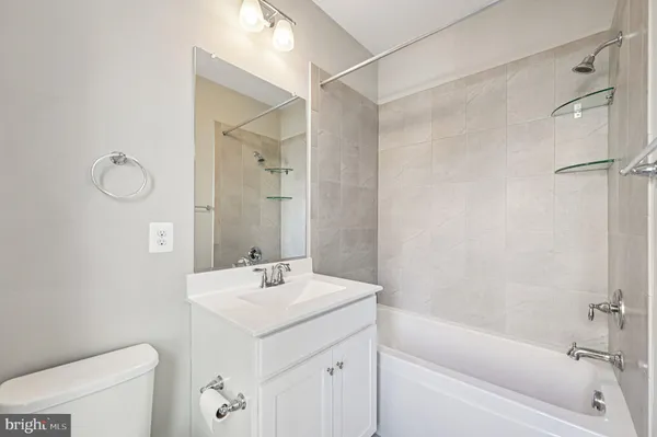 a bathroom with a sink mirror vanity and toilet