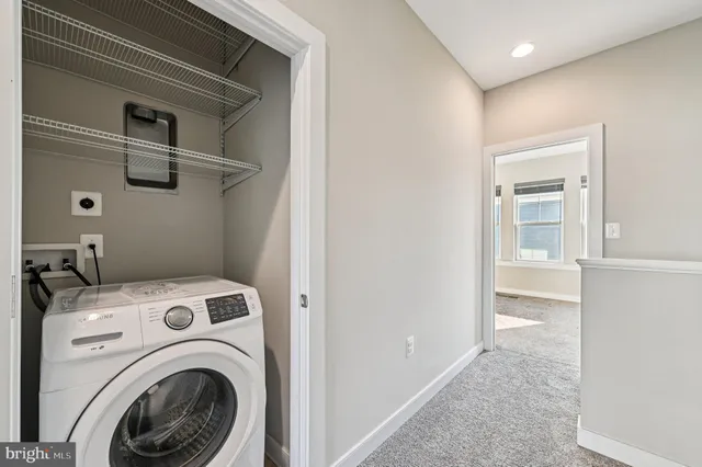 a view of storage and utility room with washer and dryer