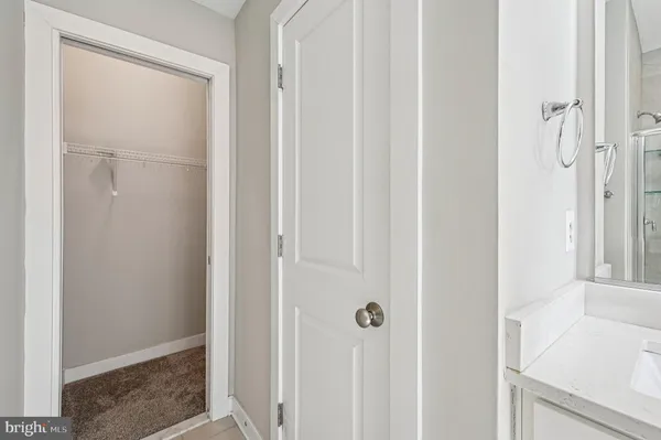 a bathroom with double vanity sinks and a large mirror