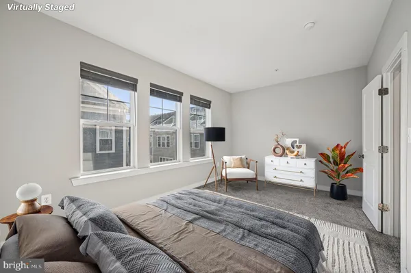 a bedroom with a bed and a couch