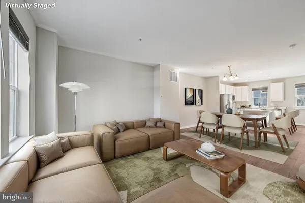 a living room with furniture couches and a window