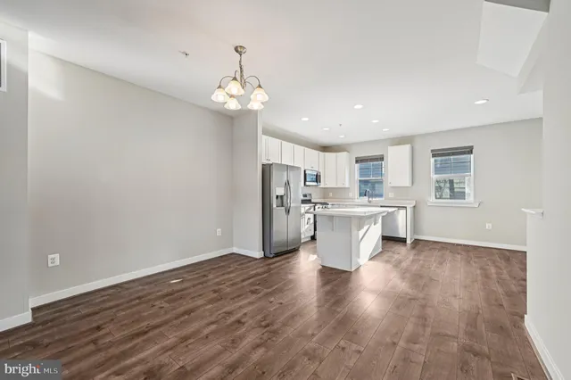 a view of a kitchen with a sink wooden floor and a window