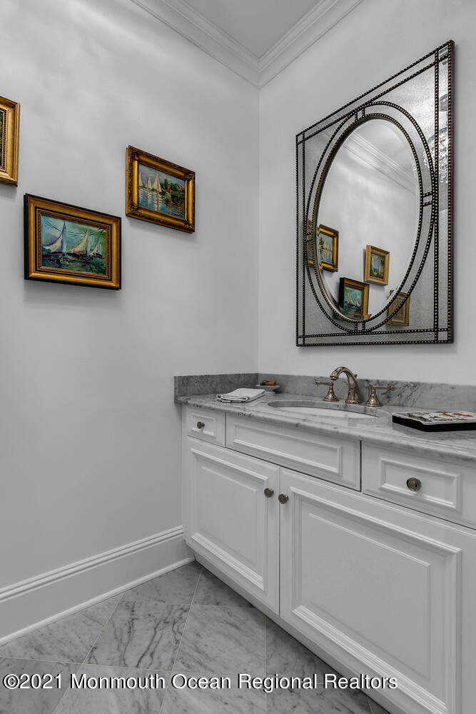 299 Cooper Road Middletown, NJ 07701 - Photo 13 of 27 a bathroom with a sink a vanity and a mirror