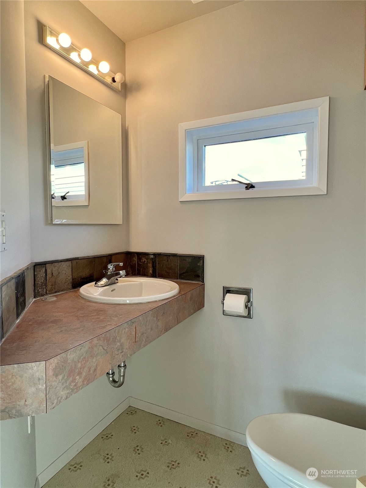 2219 Fairview Avenue East, Unit 11 Seattle, WA 98102 - Photo 11 of 15 a bathroom with a sink and a mirror