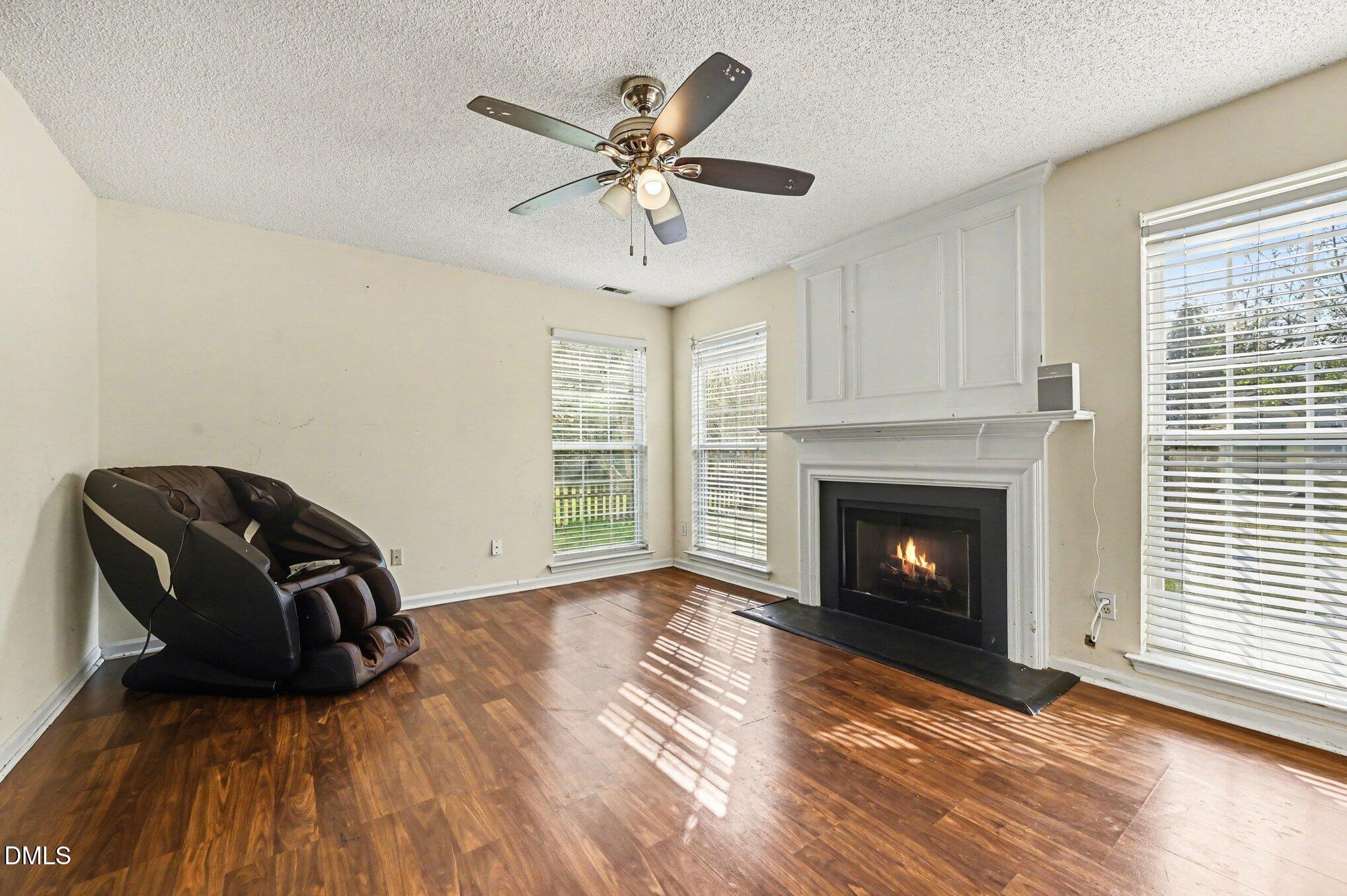 5115 Cardinal Grove Boulevard Raleigh, NC 27616 - Photo 2 of 36 a view of a livingroom with a fireplace window and wooden floor