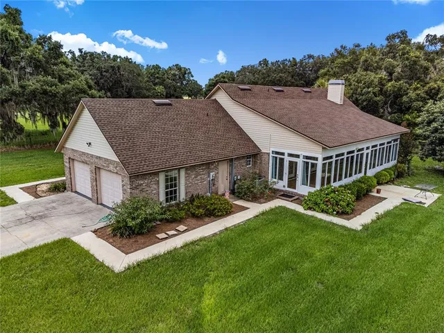 a view of empty room with wooden floor and windows