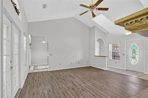 a view of empty room with wooden floor and fireplace
