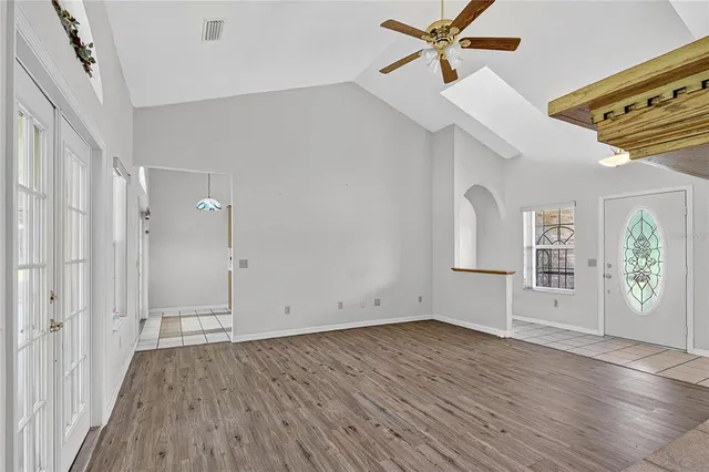 a view of empty room with wooden floor and fireplace