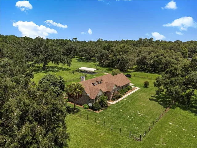 an aerial view of a house with mountain view