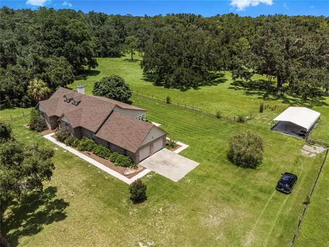 a aerial view of a house with a big yard