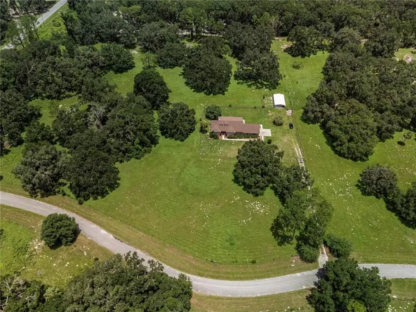 aerial view of a house with a yard