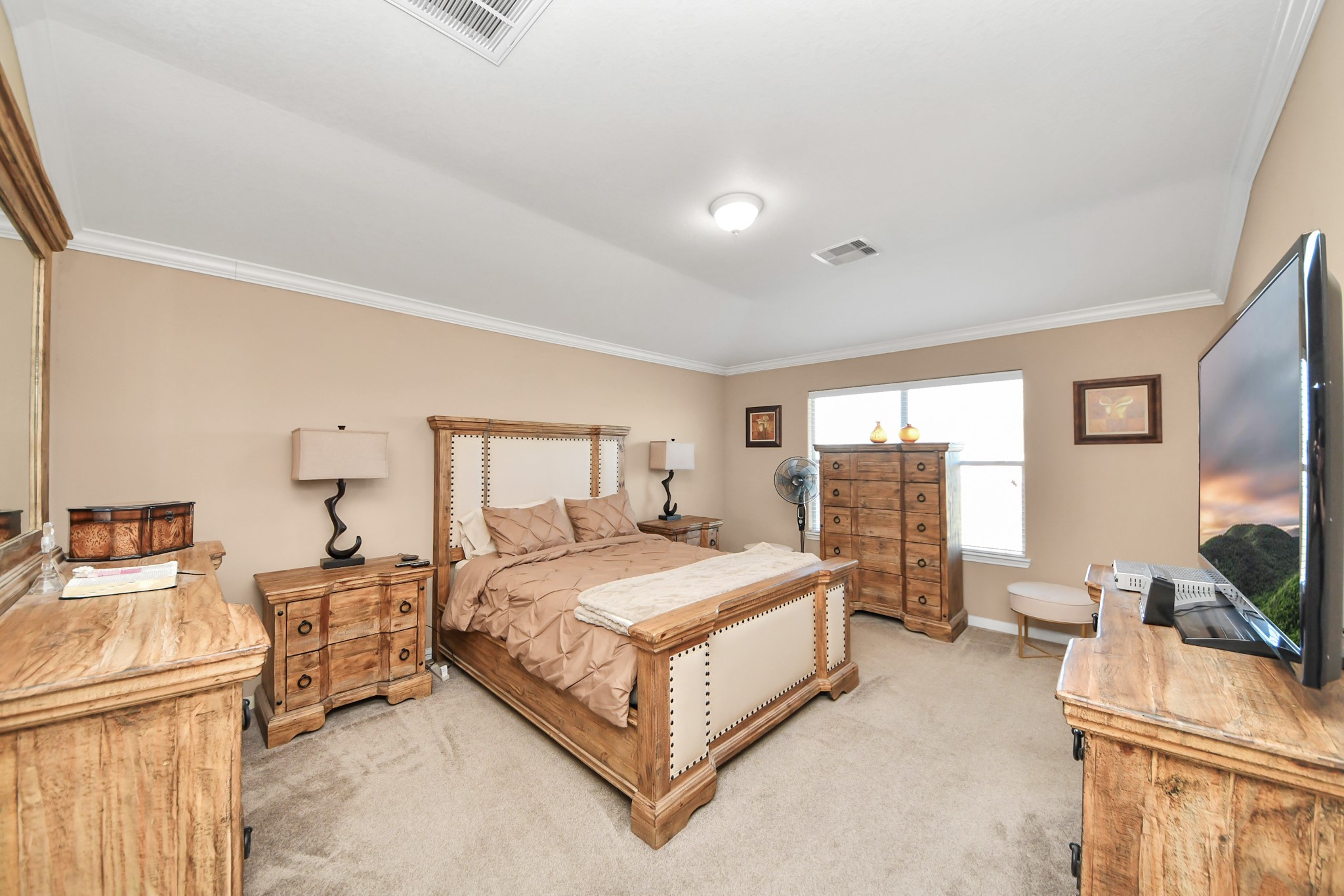 6902 Anson Point Lane Houston, TX 77040 - Photo 20 of 40 a spacious bedroom with a bed and large windows