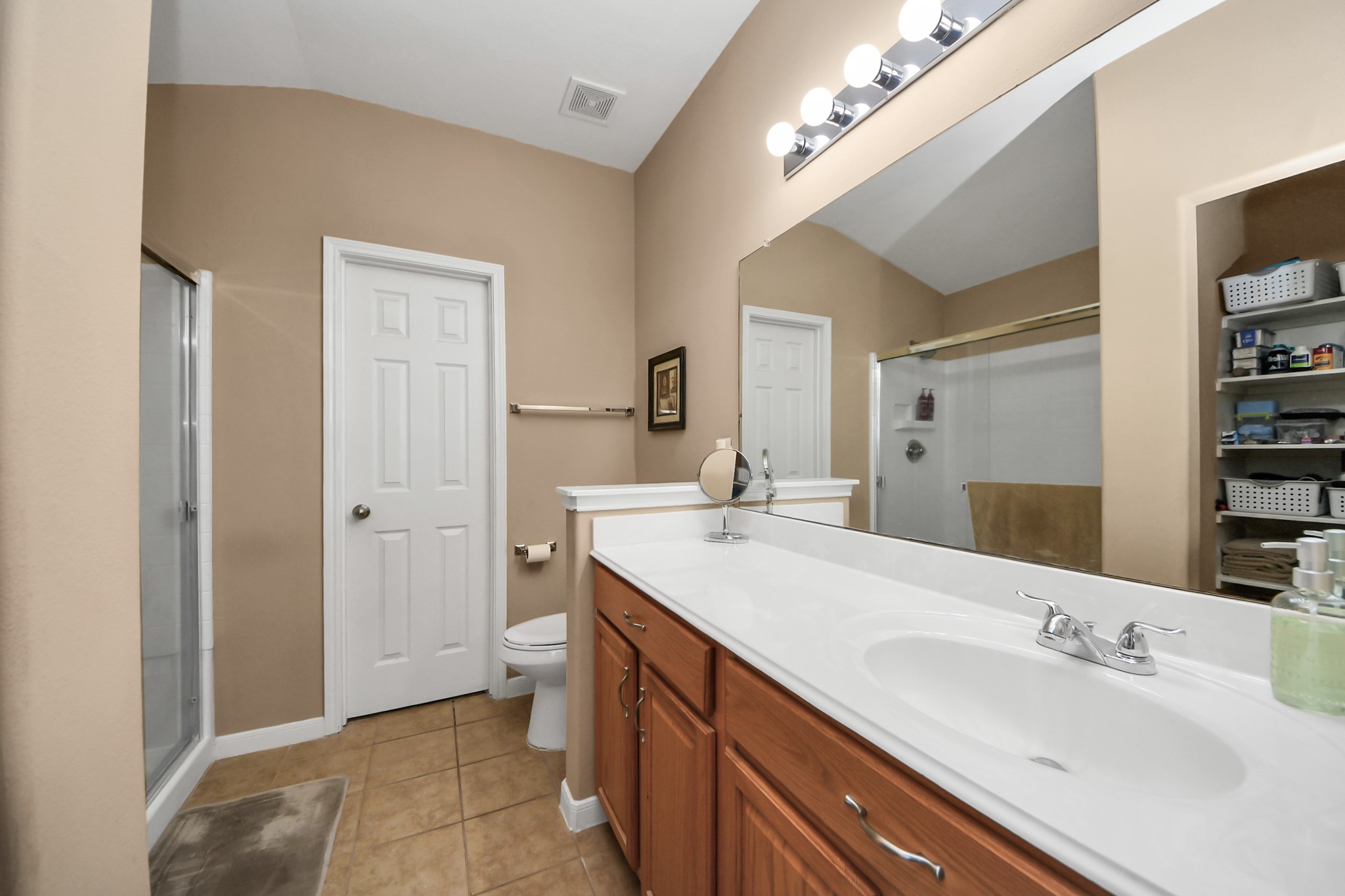 6902 Anson Point Lane Houston, TX 77040 - Photo 24 of 40 a spacious bathroom with a double vanity sink and a mirror