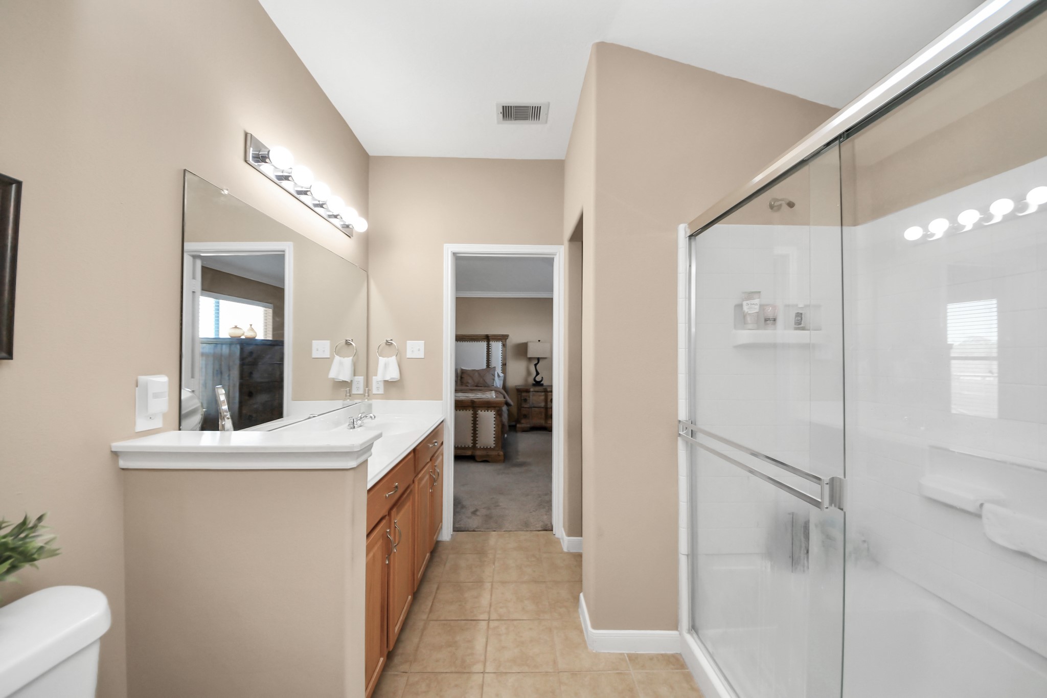 6902 Anson Point Lane Houston, TX 77040 - Photo 25 of 40 a bathroom with a double vanity sink a toilet and a mirror
