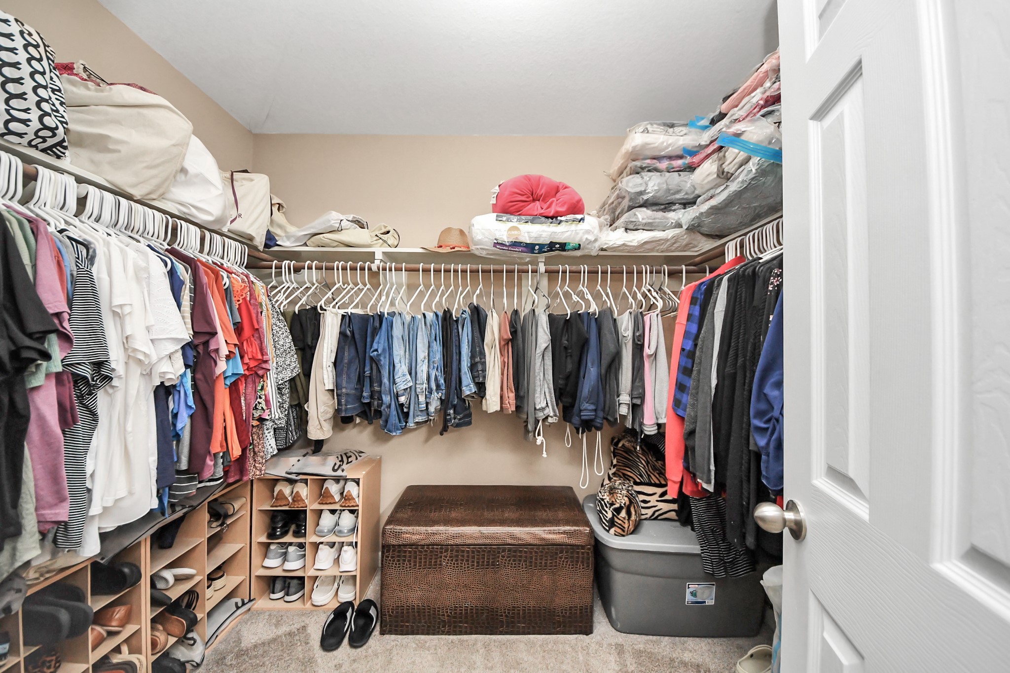 6902 Anson Point Lane Houston, TX 77040 - Photo 26 of 40 a view of walk in closet with clothes