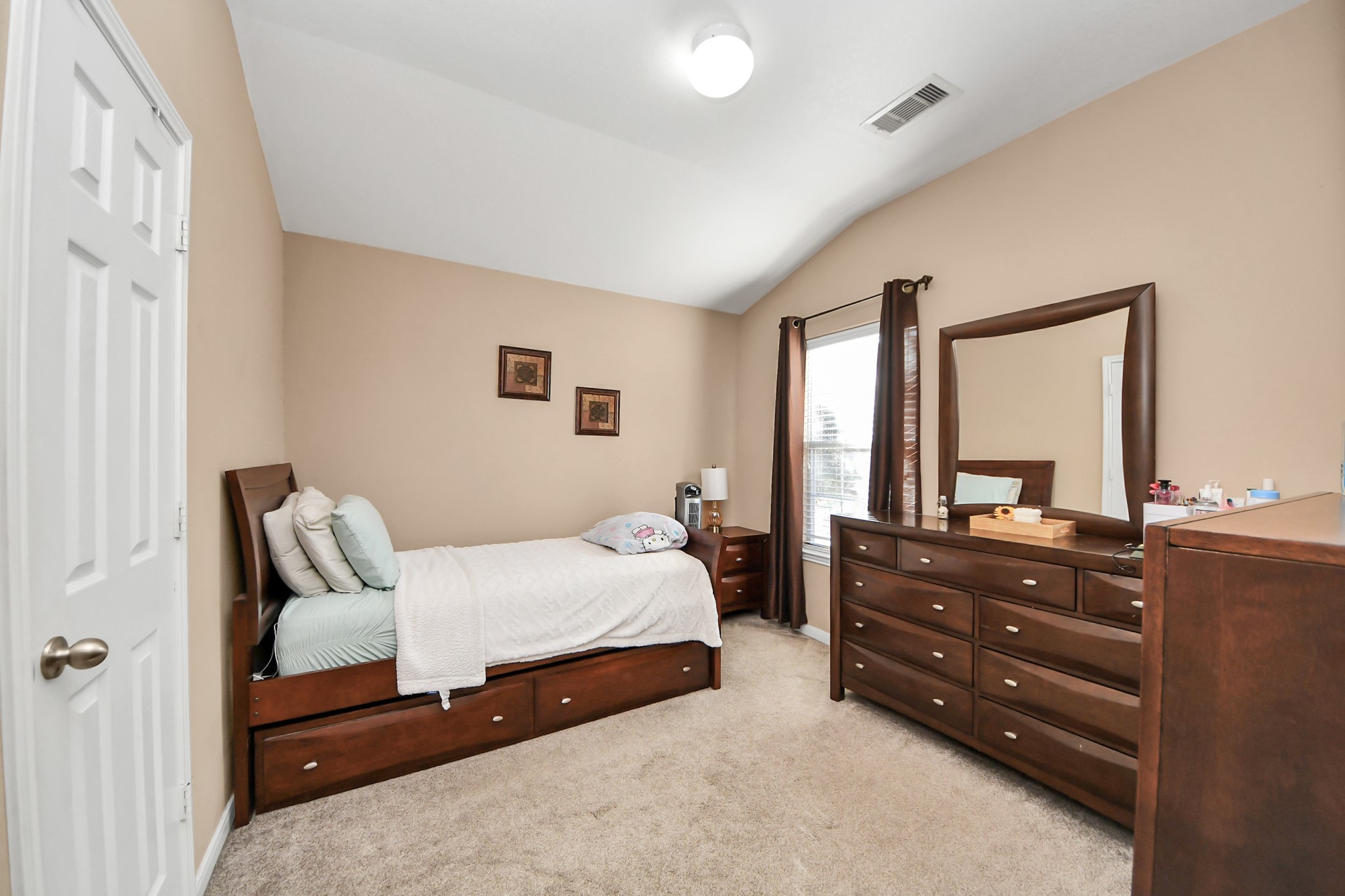 6902 Anson Point Lane Houston, TX 77040 - Photo 30 of 40 a bedroom with a bed and a dresser
