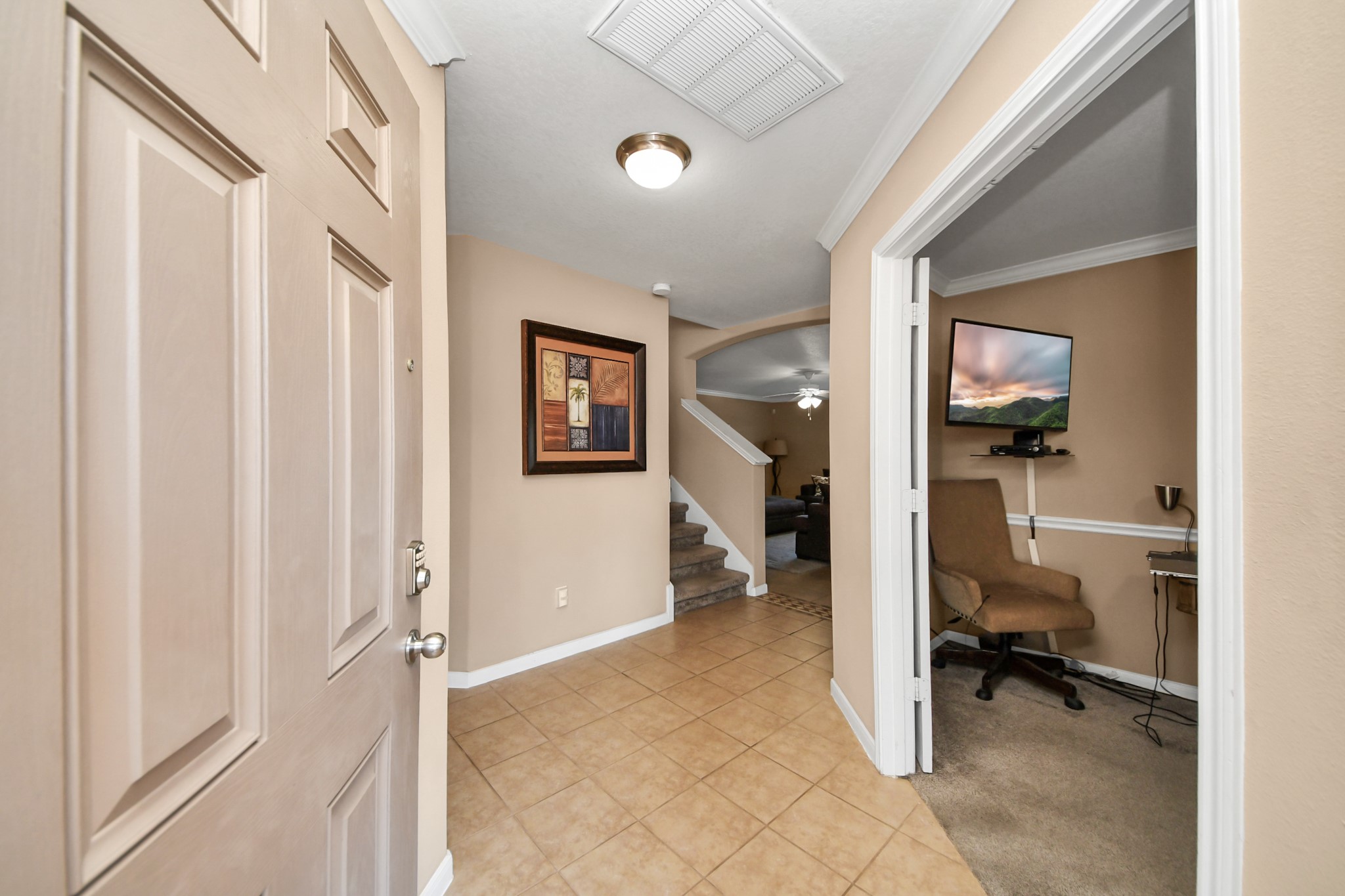 6902 Anson Point Lane Houston, TX 77040 - Photo 3 of 40 a view of a hallway and a livingroom with wooden floor and furniture