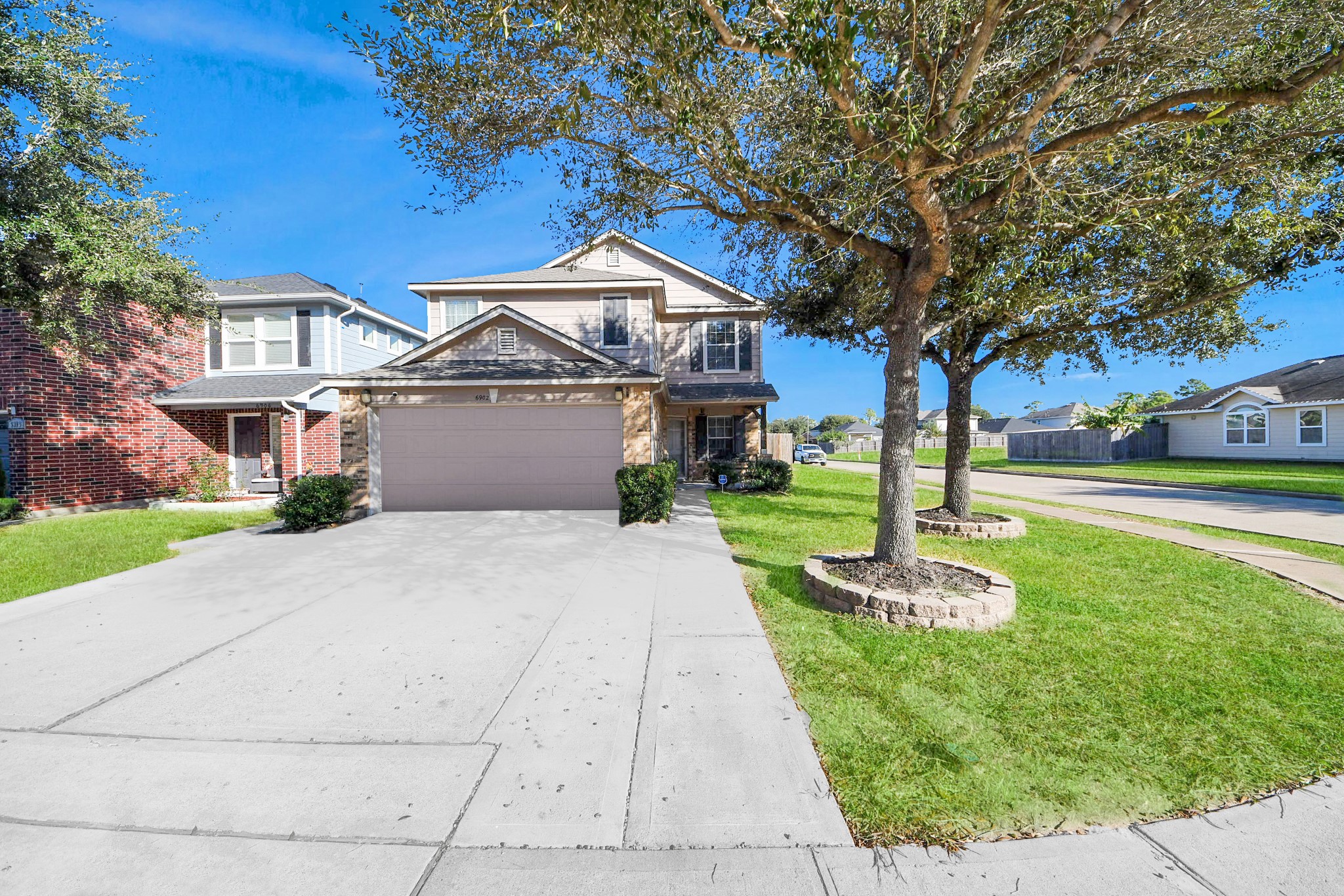 6902 Anson Point Lane Houston, TX 77040 - Photo 39 of 40 a front view of a house with a yard and trees