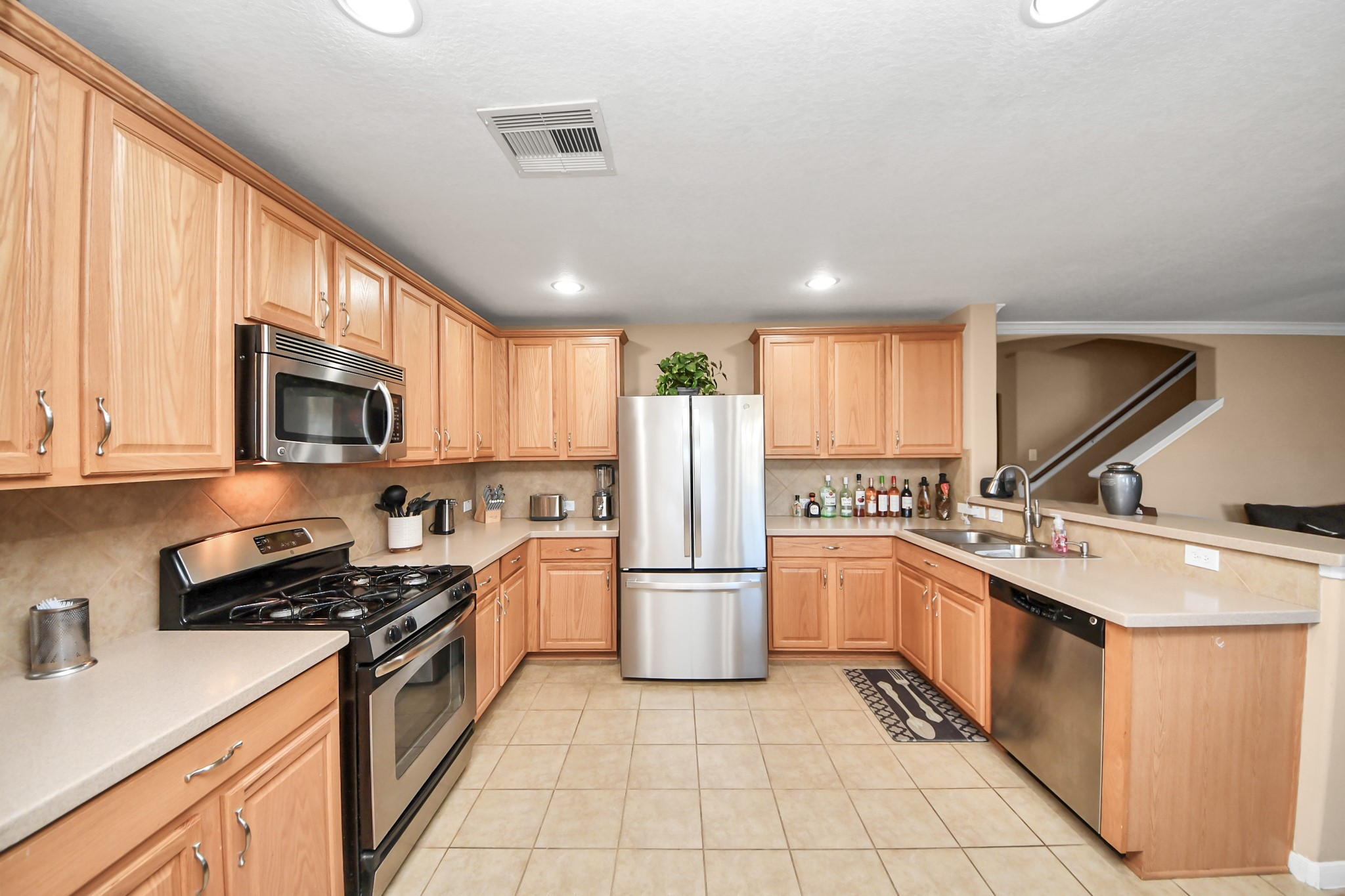 6902 Anson Point Lane Houston, TX 77040 - Photo 5 of 40 a kitchen with a sink a stove top oven and refrigerator