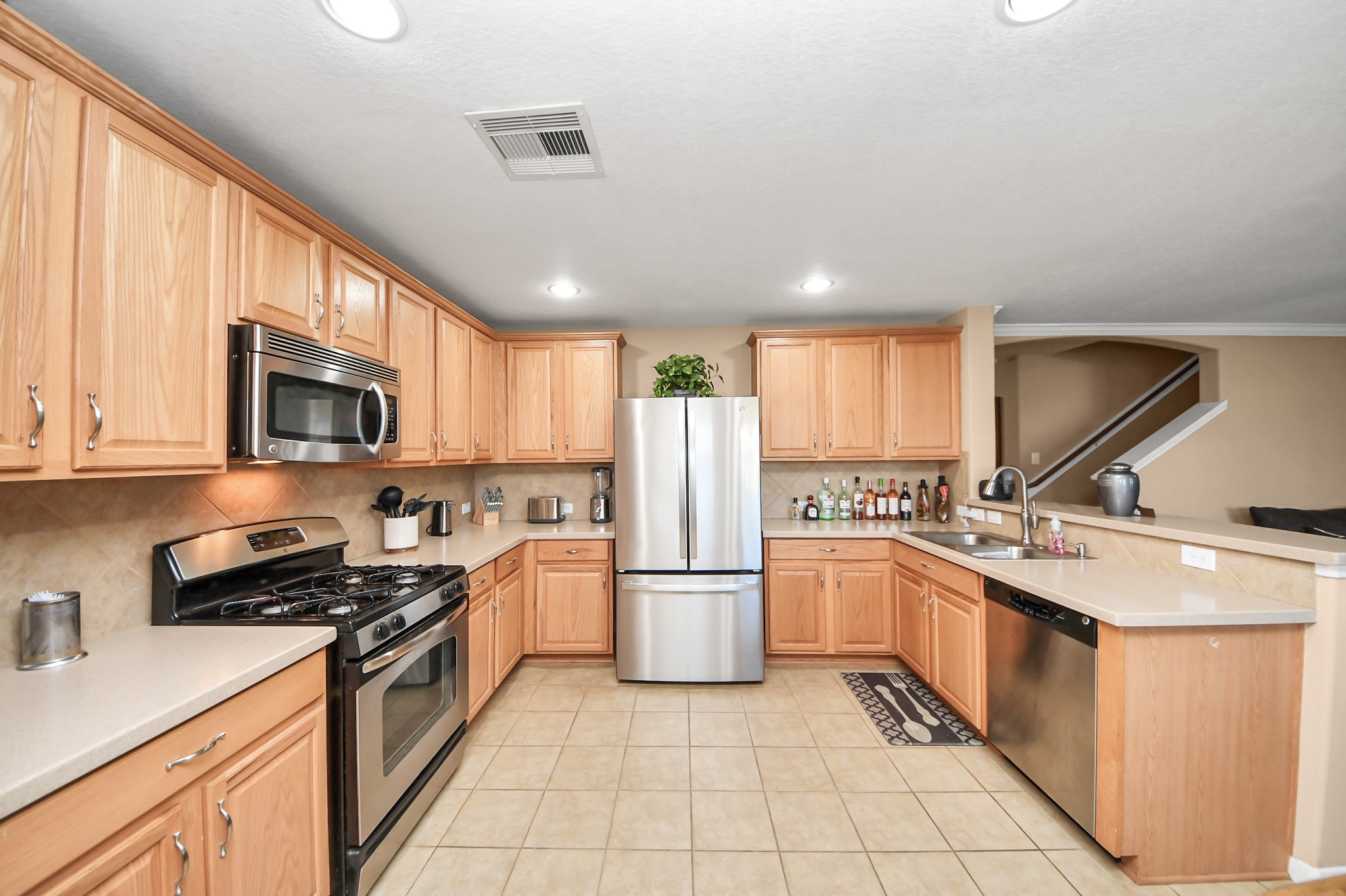 6902 Anson Point Lane Houston, TX 77040 - Photo 8 of 40 a kitchen with a sink a stove and refrigerator