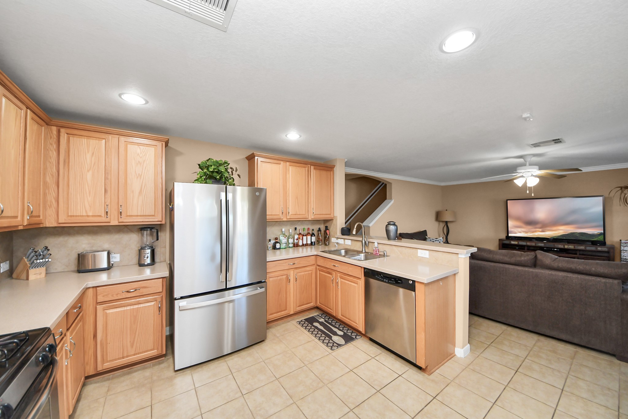6902 Anson Point Lane Houston, TX 77040 - Photo 9 of 40 a kitchen with stainless steel appliances granite countertop a refrigerator a stove a sink and a microwave
