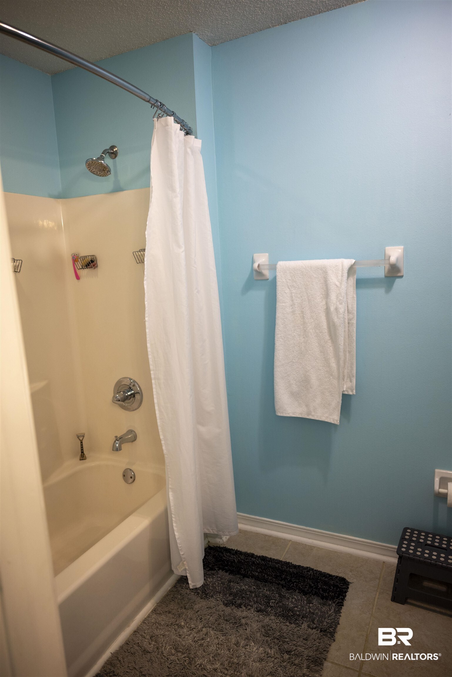808 Wisteria Lane Foley, AL 36535 - Photo 12 of 19 Bathroom featuring a textured ceiling, shower / bath combo, and tile patterned floors