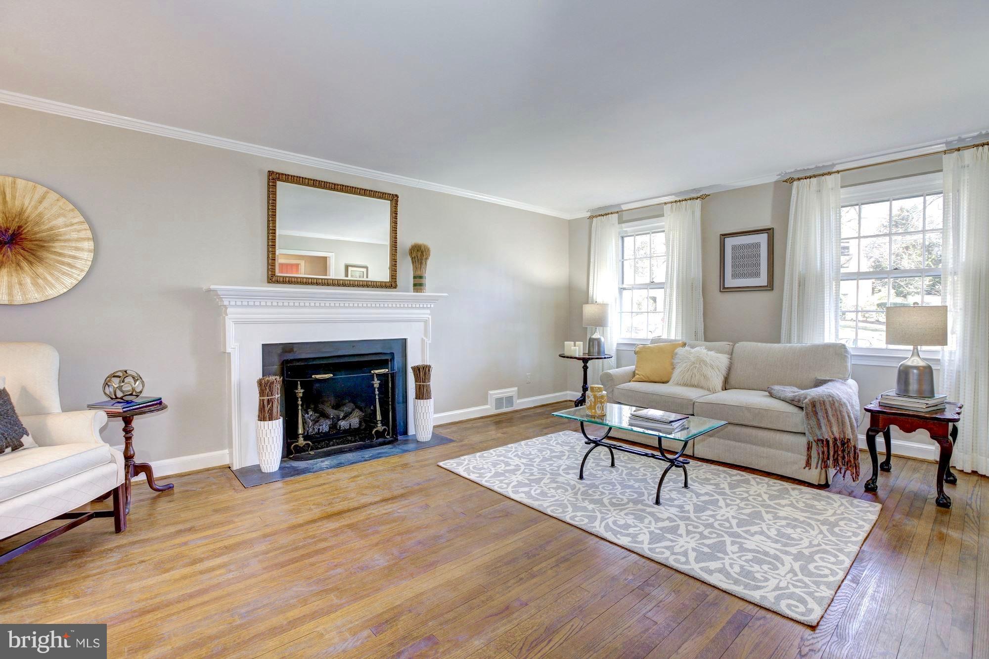 9904 Old Spring Road Kensington, MD 20895 - Photo 4 of 29 Gas fireplace and large windows in living room.