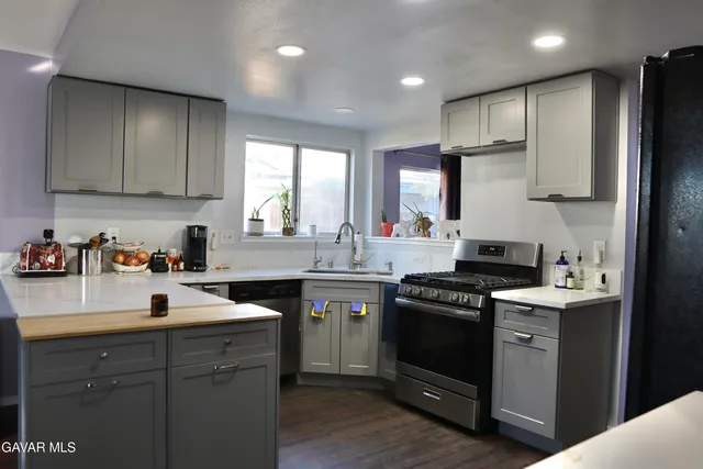 a kitchen with a sink stove and refrigerator