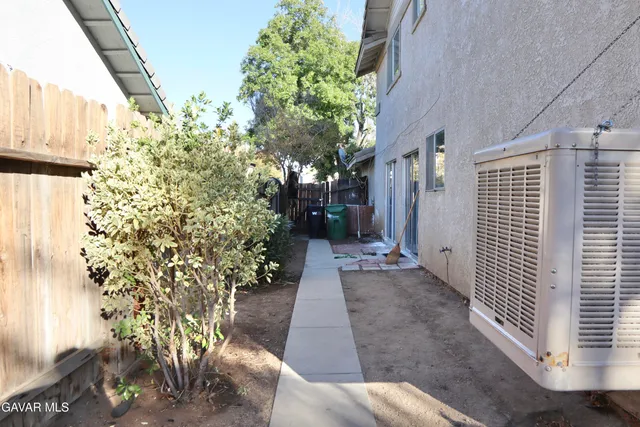 a view of a pathway of a house with flower plants