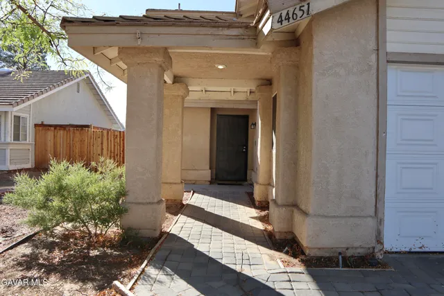 a view of house with backyard and sitting area