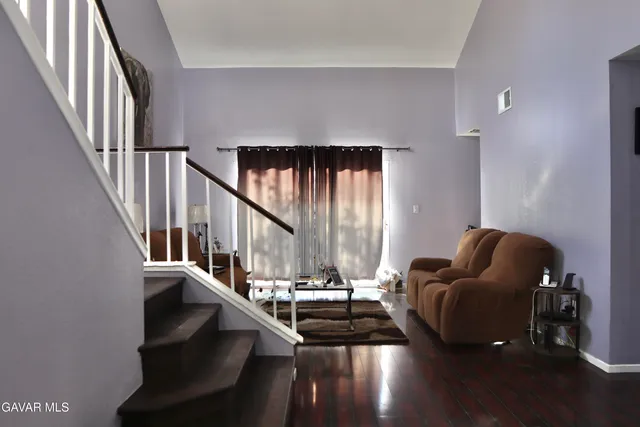 a living room with furniture or stairs and a wooden floor