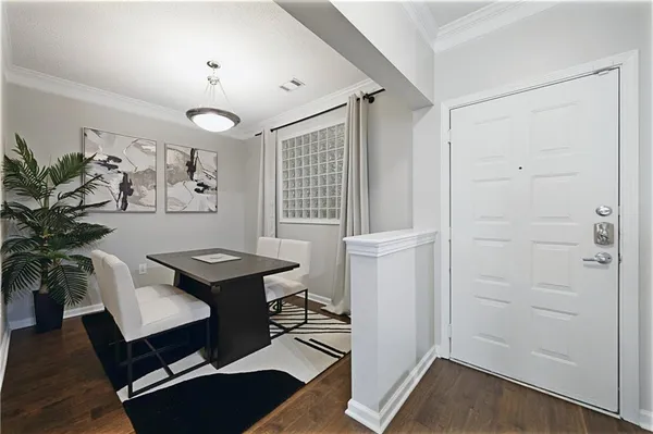 a living room with furniture and a flat screen tv with kitchen view