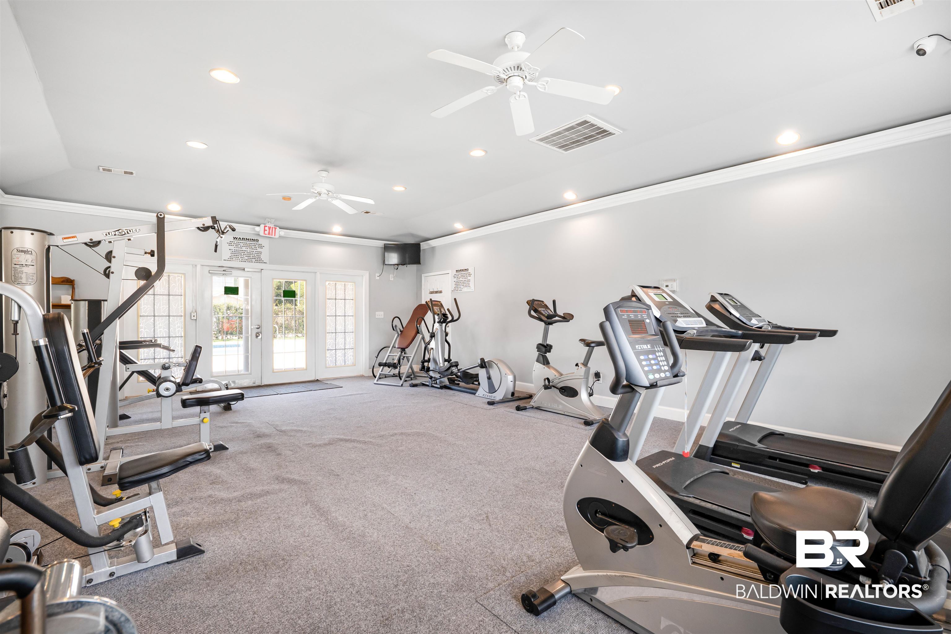 1517 Regency Road, Unit 68 Gulf Shores, AL 36542 - Photo 36 of 43 Workout area featuring ceiling fan, ornamental molding, and french doors