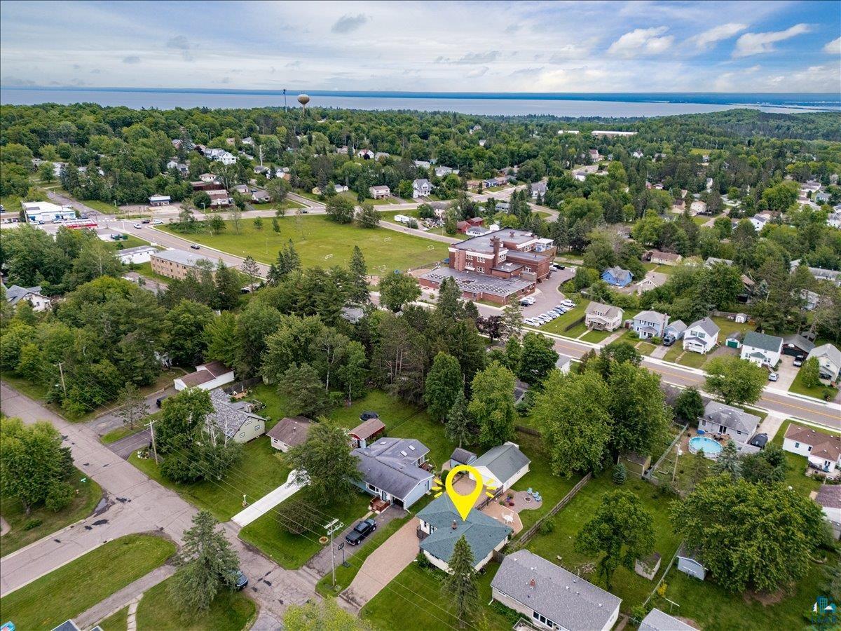 130 West Austin Street Duluth, MN 55803 - Photo 34 of 35 Aerial perspective showcasing a residential property with a green roof, set within a tree-lined neighborhood