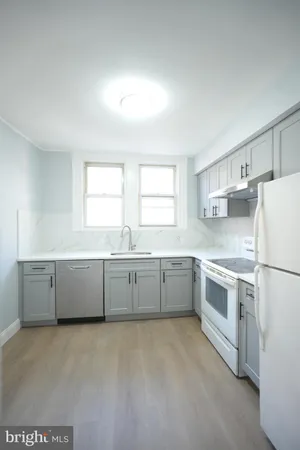 a kitchen with a white cabinets and white appliances
