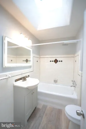 a bathroom with a sink a toilet and bathtub