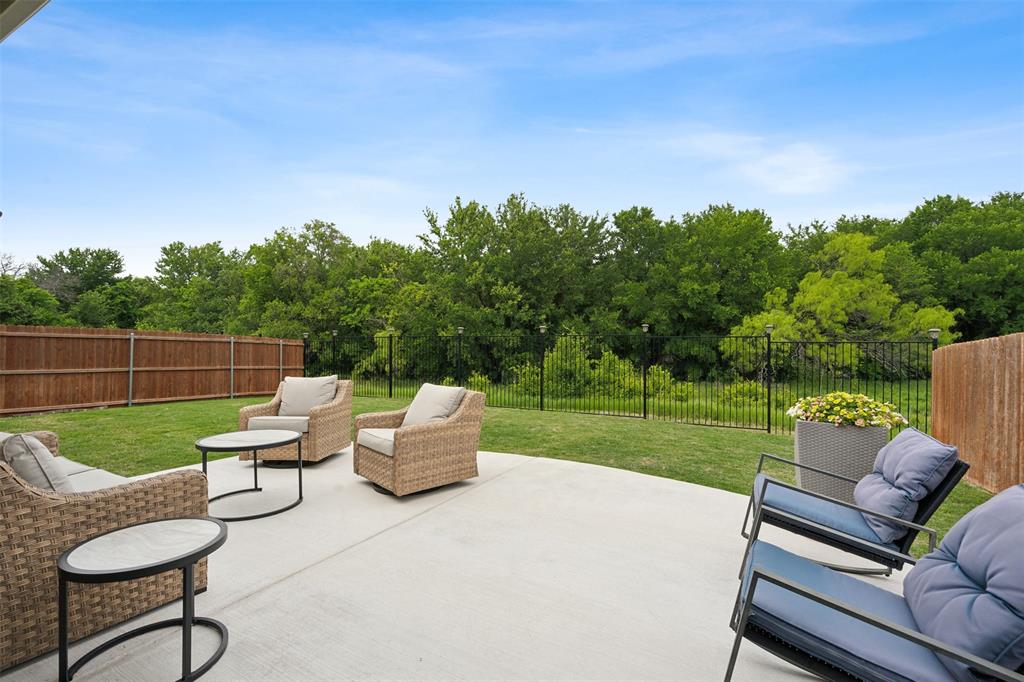 a view of a patio with couches chairs and a yard