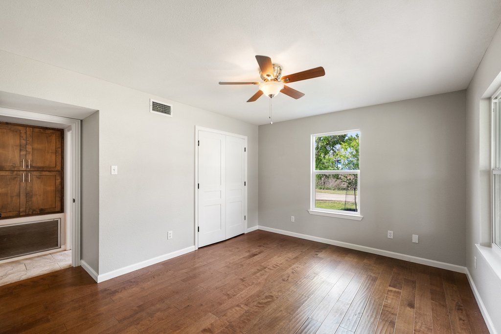 2206 Jacks Pass Austin, TX 78734 - Photo 12 of 35 an empty room with wooden floor and windows