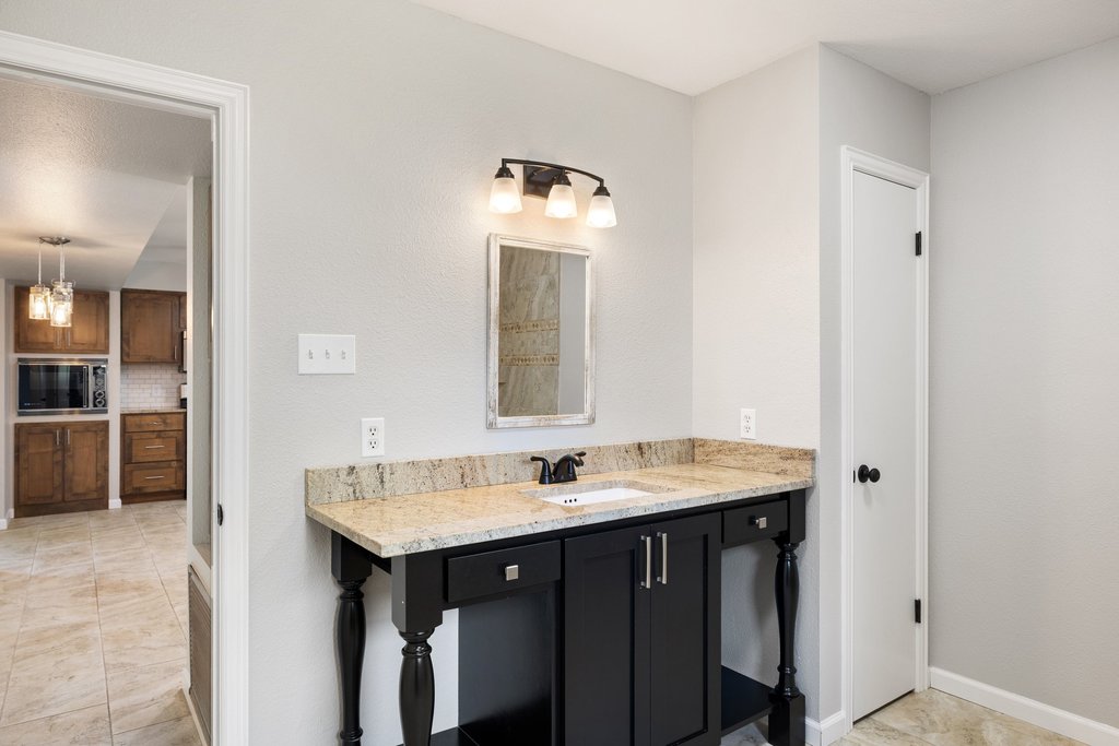 2206 Jacks Pass Austin, TX 78734 - Photo 14 of 35 a bathroom with a sink and a mirror