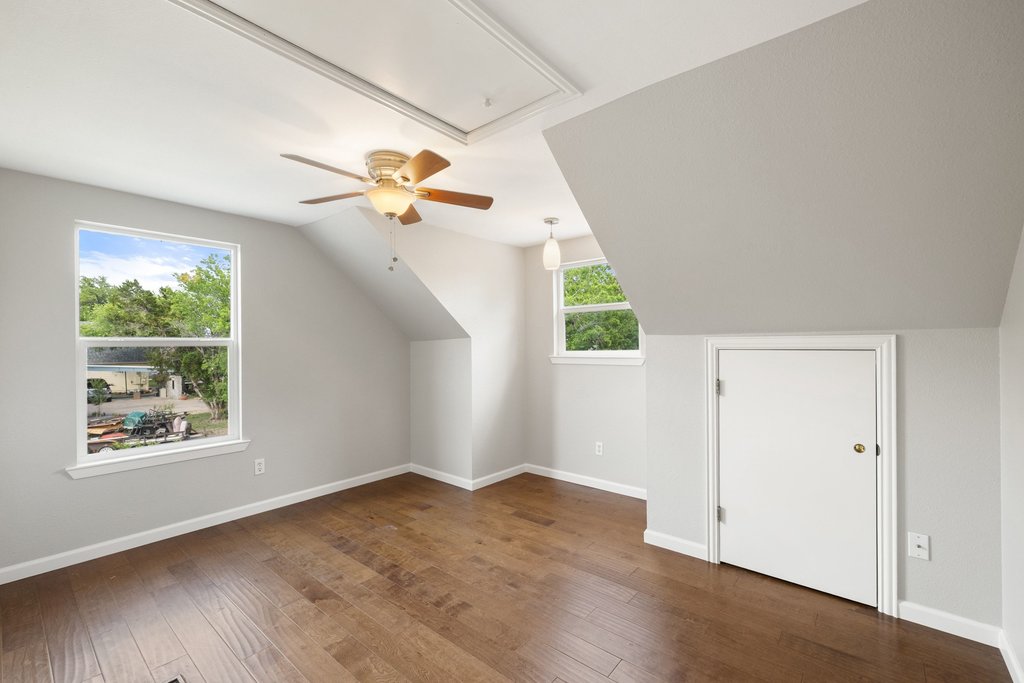 2206 Jacks Pass Austin, TX 78734 - Photo 22 of 35 an empty room with wooden floor and windows