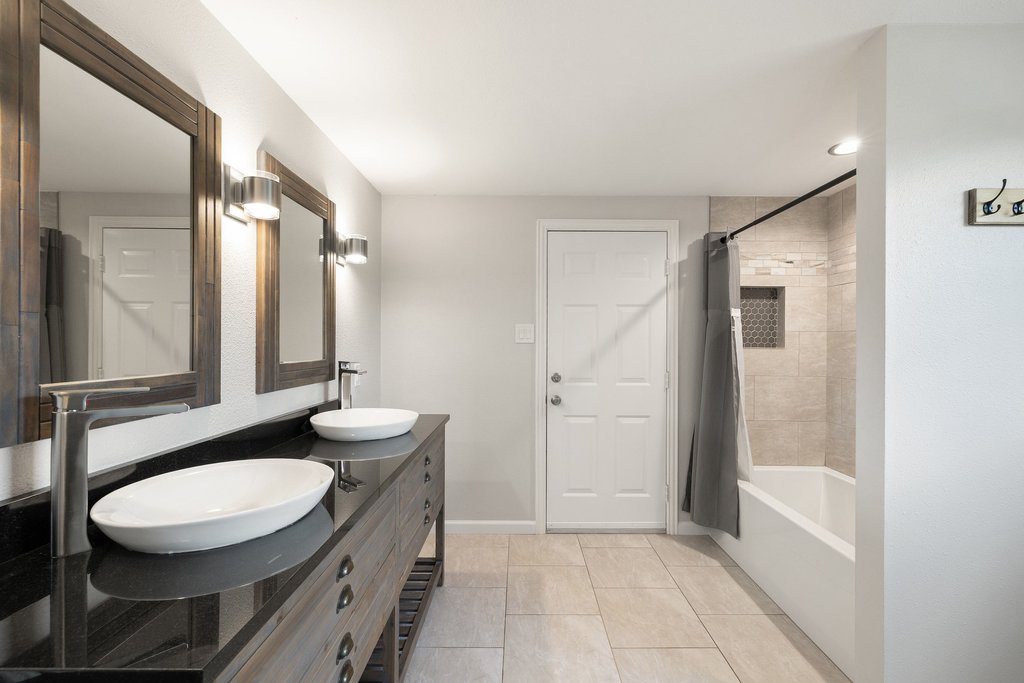 2206 Jacks Pass Austin, TX 78734 - Photo 24 of 35 a bathroom with a double vanity sink and a mirror