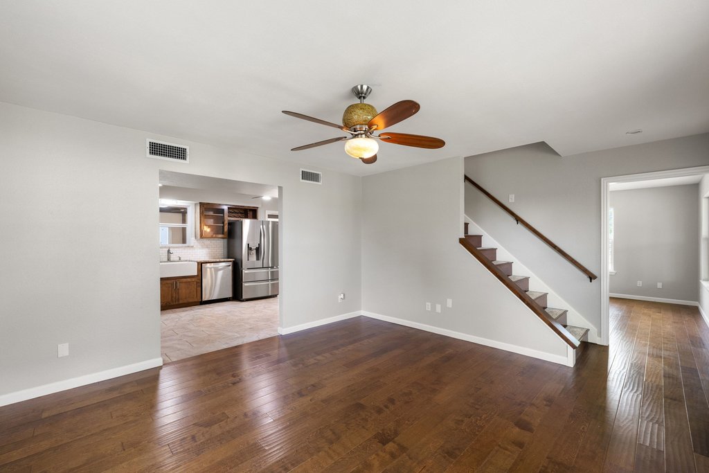 2206 Jacks Pass Austin, TX 78734 - Photo 4 of 35 a view of an empty room with wooden floor and a kitchen