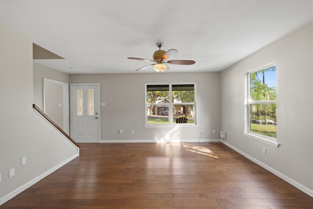 2206 Jacks Pass Austin, TX 78734 - Photo 5 of 35 an empty room with wooden floor and windows