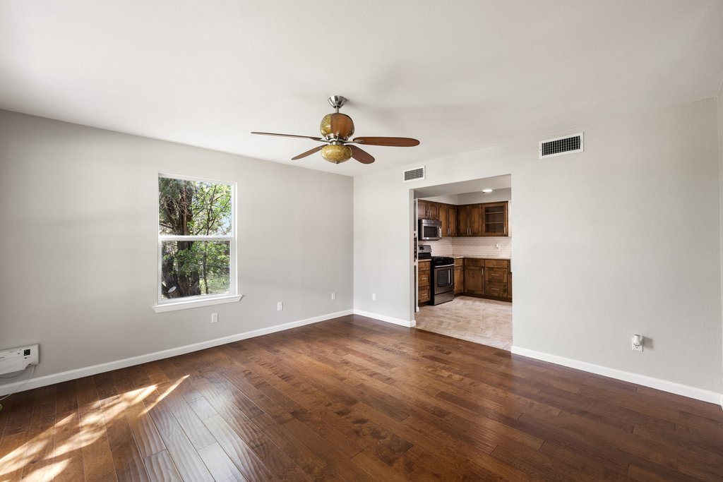 2206 Jacks Pass Austin, TX 78734 - Photo 6 of 35 a view of an empty room with a window and wooden floor