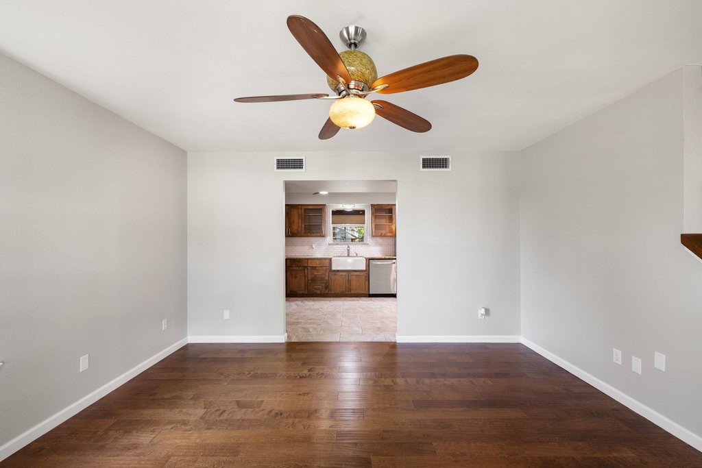 2206 Jacks Pass Austin, TX 78734 - Photo 7 of 35 a view of an empty room with wooden floor and a ceiling fan