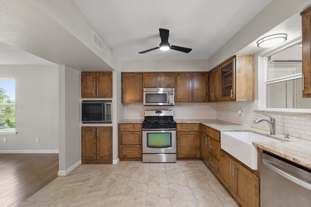 2206 Jacks Pass Austin, TX 78734 - Photo 8 of 35 a kitchen with stainless steel appliances granite countertop a refrigerator and a sink