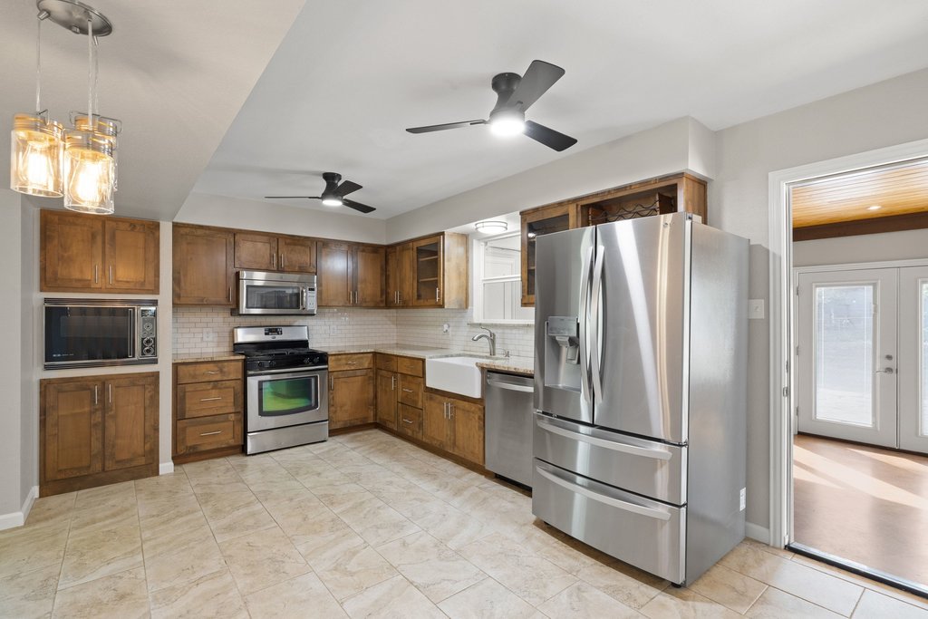 2206 Jacks Pass Austin, TX 78734 - Photo 9 of 35 a kitchen with granite countertop stainless steel appliances cabinets a sink and a counter top space